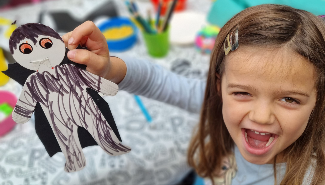 Little Girl very excited about vampire she has made with The Kids' Table