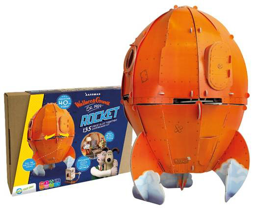 Bright Orange Wallace and Gromit Rocket made from cardboard stands in front of the box it came in