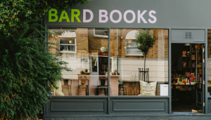Exterior of Bard Books, a charming independent bookstore on Roman Road, featuring a cozy storefront with large windows showcasing books and inviting interiors