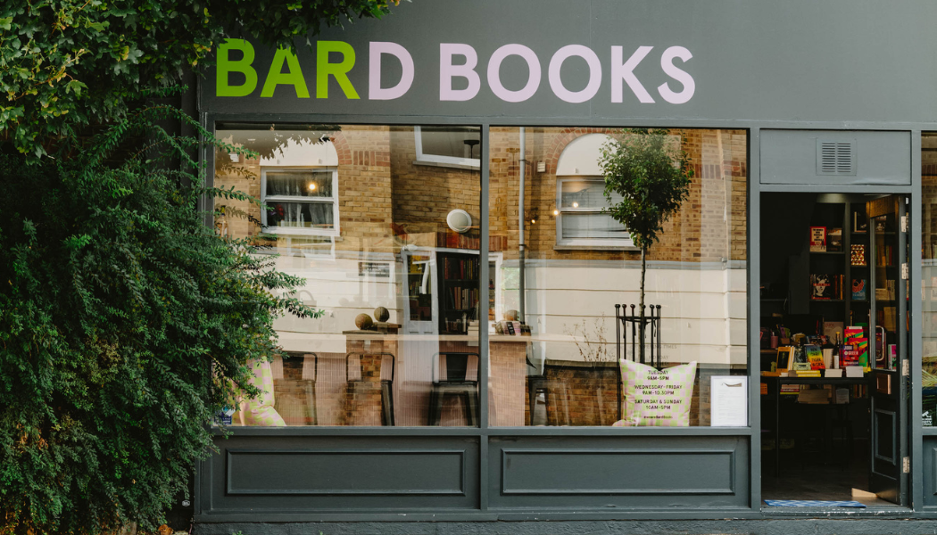 Exterior of Bard Books, a charming independent bookstore on Roman Road, featuring a cozy storefront with large windows showcasing books and inviting interiors