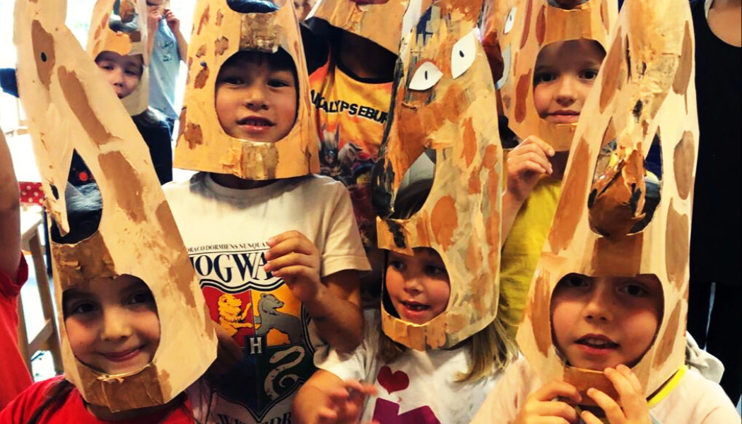 Kids get crafty with Giraffe head dress at The Art Imaginarium Summer Camp in Hackney and Tower Hamlets