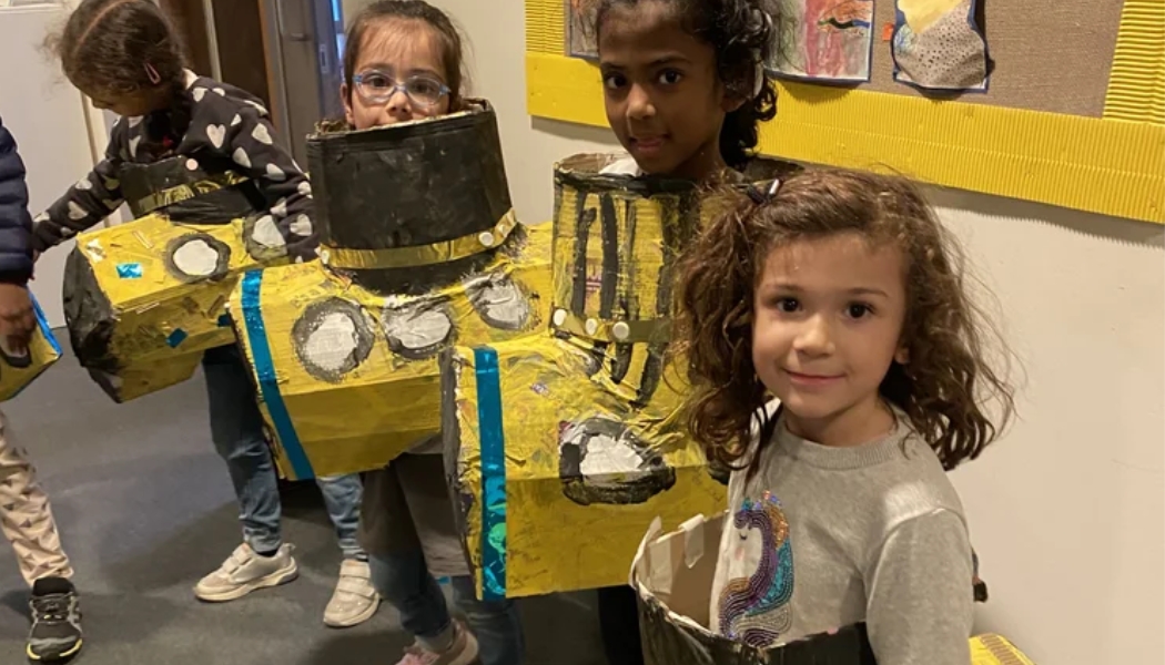 The Art Imaginarium Holiday camp in Hackney and Bethnal Green returns this October Half term. This photo is of some children getting stuck into paper mache yellow submarines