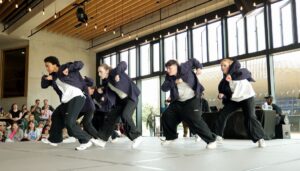 Breakin Convention hip hop dancers dressed in black and white streetwear perform for families at Sadler's Wells East